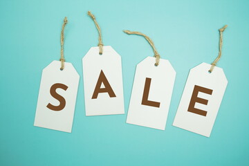 White Tags With SALE alphabet letters on blue background