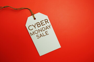 Flat lay Cyber Monday Sale tag on red background