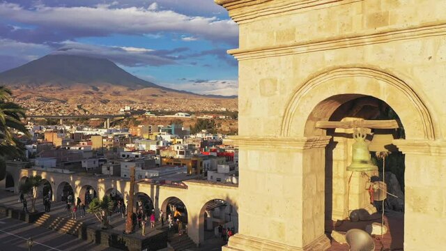 Arequipa bell tower and volcano during sunset drone