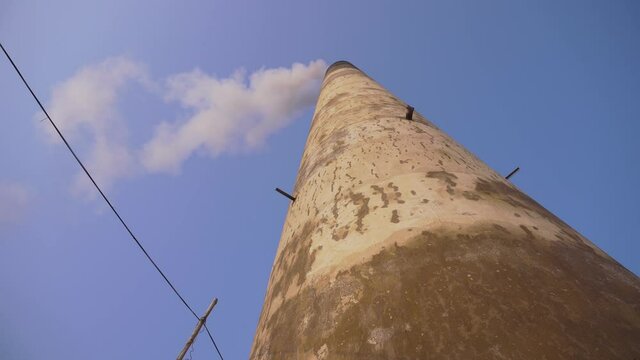 Smoke is coming out of the furnace which is mixed with the air.