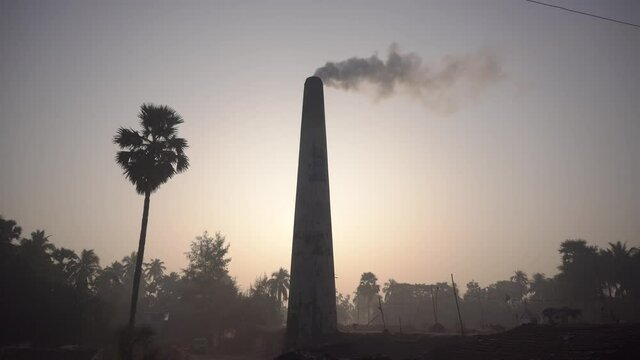 Smoke is coming out of the furnace which is mixed with the air.