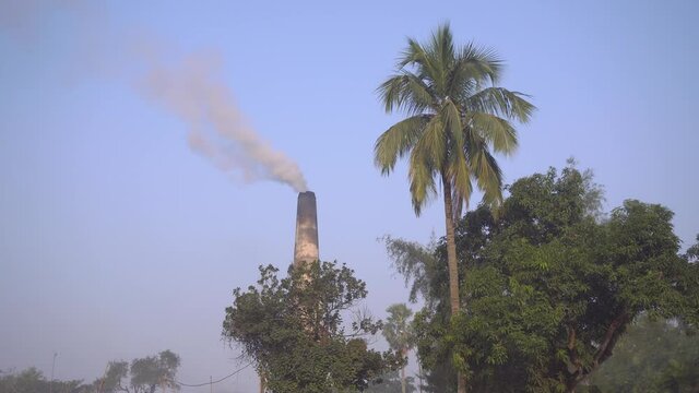 Smoke is coming out of the furnace which is mixed with the air.