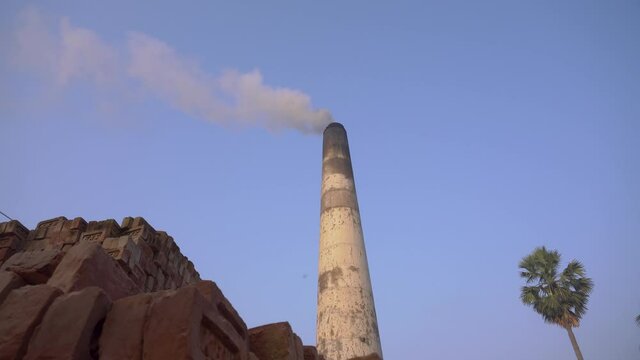 Smoke is coming out of the furnace which is mixed with the air.