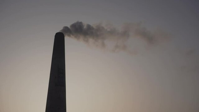 Smoke is coming out of the furnace which is mixed with the air.