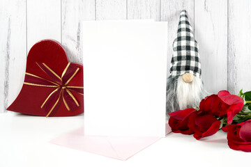 Greeting Card product mockup. Valentine's Day farmhouse theme SVG craft product mockup styled with red roses, heart shaped gift, and buffalo plaid gnome against a white wood background.
