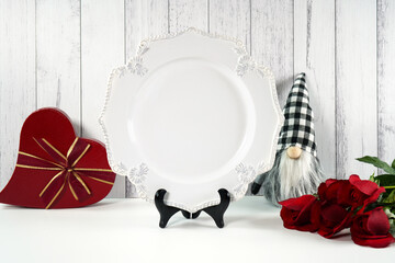 Dinner plate product mockup. Valentine's Day farmhouse theme SVG craft product mockup styled with red roses, heart shaped gift, and buffalo plaid gnome against a white wood background.