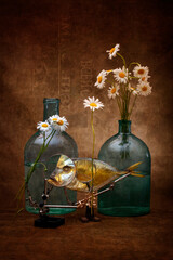 Still life with moonfish, a bouquet of daisies and glass bottles