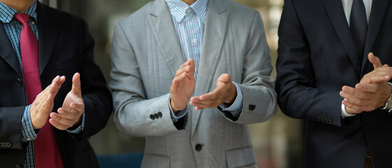Fototapeta premium Successful executive manager or businessmen in formal suit clapping their hands