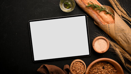 Digital tablet mockup with a French bread on black background.