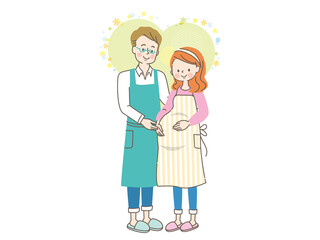 妊娠中の笑顔の女性とエプロン姿の夫