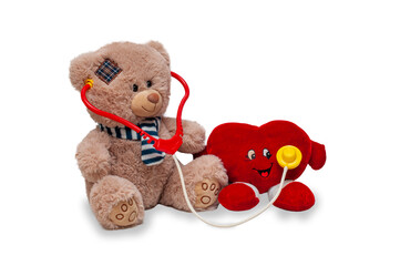 A teddy bear listens to a toy heart with a fanendoscope. Provision of medical care. Isolated children's toys on a white background.