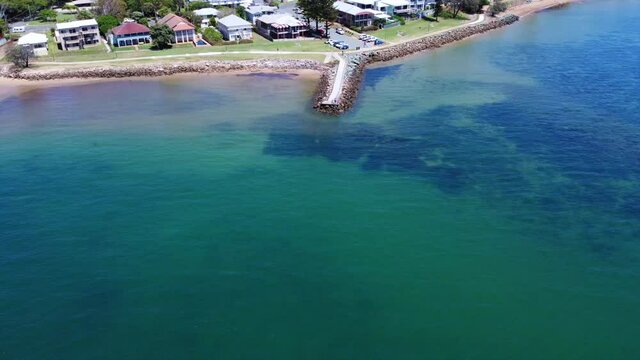 Flying away off pier Redcliffe Queensland. Aerial panoramic bay and city view. Sunny day