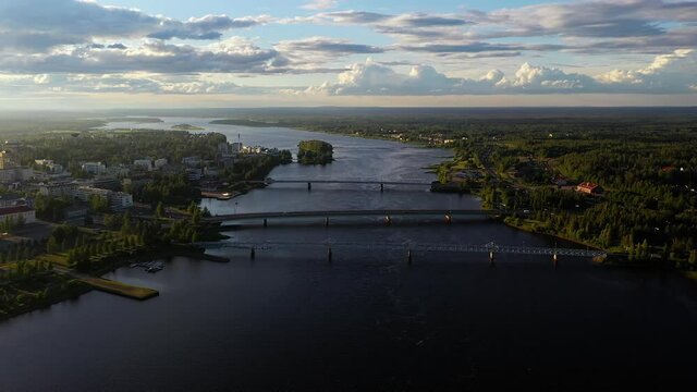 Aerial view of bridges in to Tornio, summer evening in Finland - circling, drone shot
