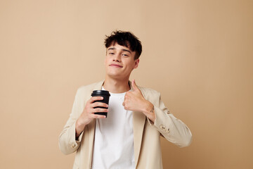 Photo young boyfriend black disposable glass in the hands of posing fashion light background unaltered