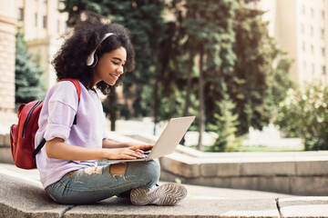 African American Female Student Using Laptop Learning Sitting Outdoor