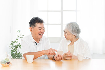 Obraz na płótnie Canvas スマホを使う高齢者夫婦（笑顔） 