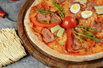 Children's pizza in the shape of a cat's face on a white plate, on a white background, top view. Children's menu