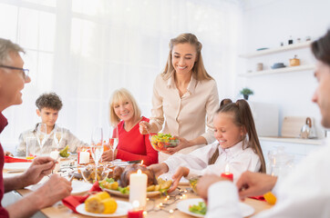 Obraz na płótnie Canvas Happy extended multi generation family celebrating Thanksgiving or Christmas with festive turkey at home