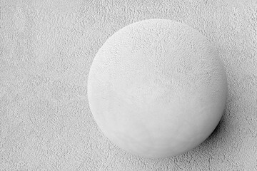 3D rendering. White volumetric sphere covered with decorative plaster. Close-up geometric figure of the ball on a white background