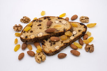 Slices of sweet dessert multigrain bread with nuts, almonds, walnuts and raisins. Healthy diet. Isolated on white background.