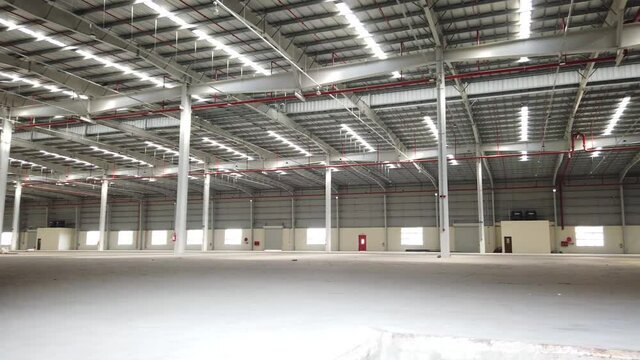 Newly constructed empty warehouse in an industrial area with fire safety systems installed