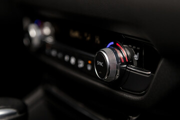 Fototapeta premium Close up Instrument automobile panel with climat control view with air conditioning buttons- details and controls of modern car.