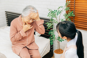 高齢者女性と介護士の女性（悩む・頭痛）
