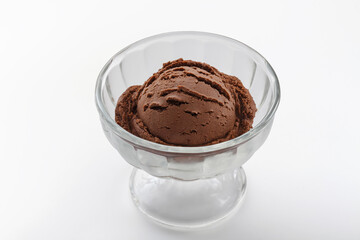 One scoop of chocolate ice cream in glass cup on white background