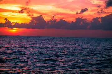 The background of the sea by the evening sea, with natural beauty (sea water, rocks, sky) and fishermen are fishing by the river bank, is a pleasure during travel.