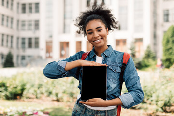 Fototapeta premium Black College Student Girl Showing Tablet Empty Screen Standing Outdoors