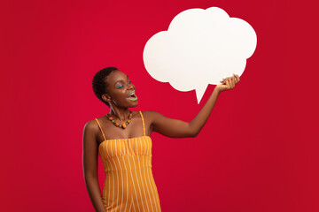 Happy black woman holding empty speech bubble