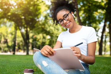 African American Millennial Girl Sketching Sitting In Park Outdoors