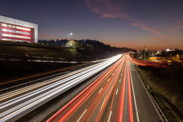 Fototapeta na wymiar Autobahn mit Verkehr bei Nacht mit Lichterstreifen in der Abenddämmerung