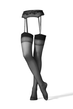 Detail shot of black stockings with a lace garter belt with a floral pattern. The stockings with a belt have a shape of woman's legs.The sexy lingerie is isolated on the white background.
