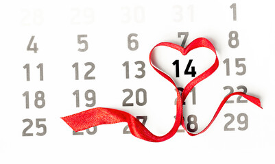 calendar with red heart shaped ribbon