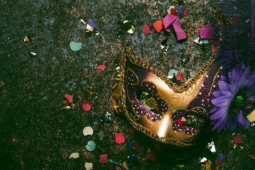 Venetian carnival mask and party confetti with copy space. Carnival celebration concept