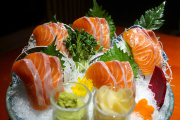 Fresh salmon sashimi is set up to be eaten.
