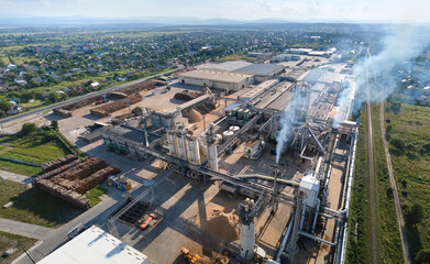 Aerial view of wood processing factory with stacks of lumber at plant manufacturing yard