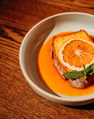 toast with an orange slice with jam on a white plate