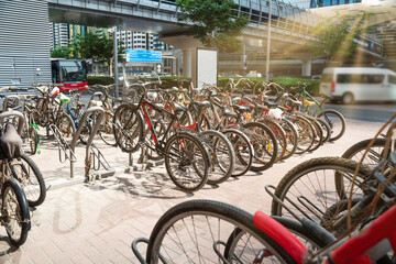 Fototapeta na wymiar Large bike parking lot in Dubai, lots of bicycles in sunlight, toned.
