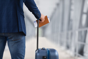Air Travels Concept. Man With Suitcase Holding Passport And Airline Tickets, Closeup - obrazy, fototapety, plakaty