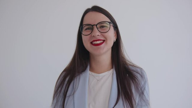 Portrait of a young laughing business lady in glasses on a white isolated background. Career and success concept