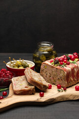 Traditional French terrine covered with bacon on dark wooden background