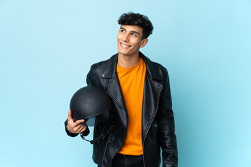 Argentinian man with a motorcycle helmet thinking an idea while looking up