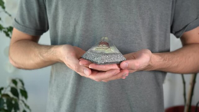 Close-up of person with orgone stone performing breathing exercises