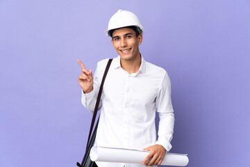 Young architect man isolated on background intending to realizes the solution while lifting a finger up