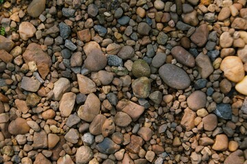 Abstract pebble background. Pebble texture in sea water. Stone background. Sea pebble beach. Beautiful nature. copy space