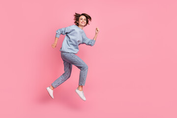 Fototapeta na wymiar Full body profile photo of sweet millennial lady run wear jumper jeans sneakers isolated on pink background