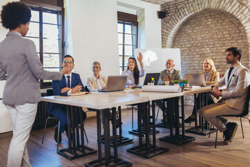 Speaker at business workshop entrepreneur giving a presentation about positive business growth to  colleagues in the office.