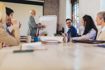 Speaker at business workshop entrepreneur giving a presentation about positive business growth to  colleagues in the office.